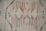 Full view of beige abstract kilim rug on floor