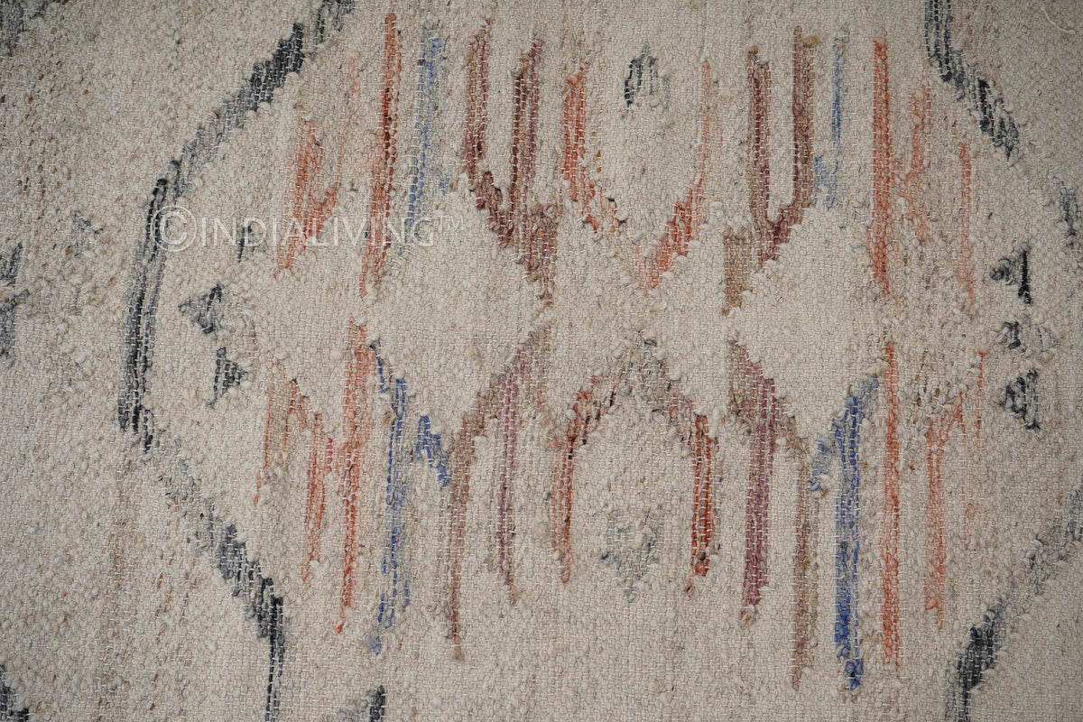 Full view of beige abstract kilim rug on floor