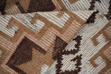Brown beige kilim rug under a sofa