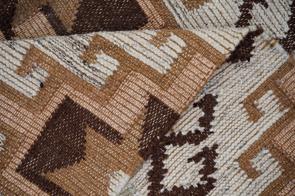 Brown beige kilim rug under a sofa