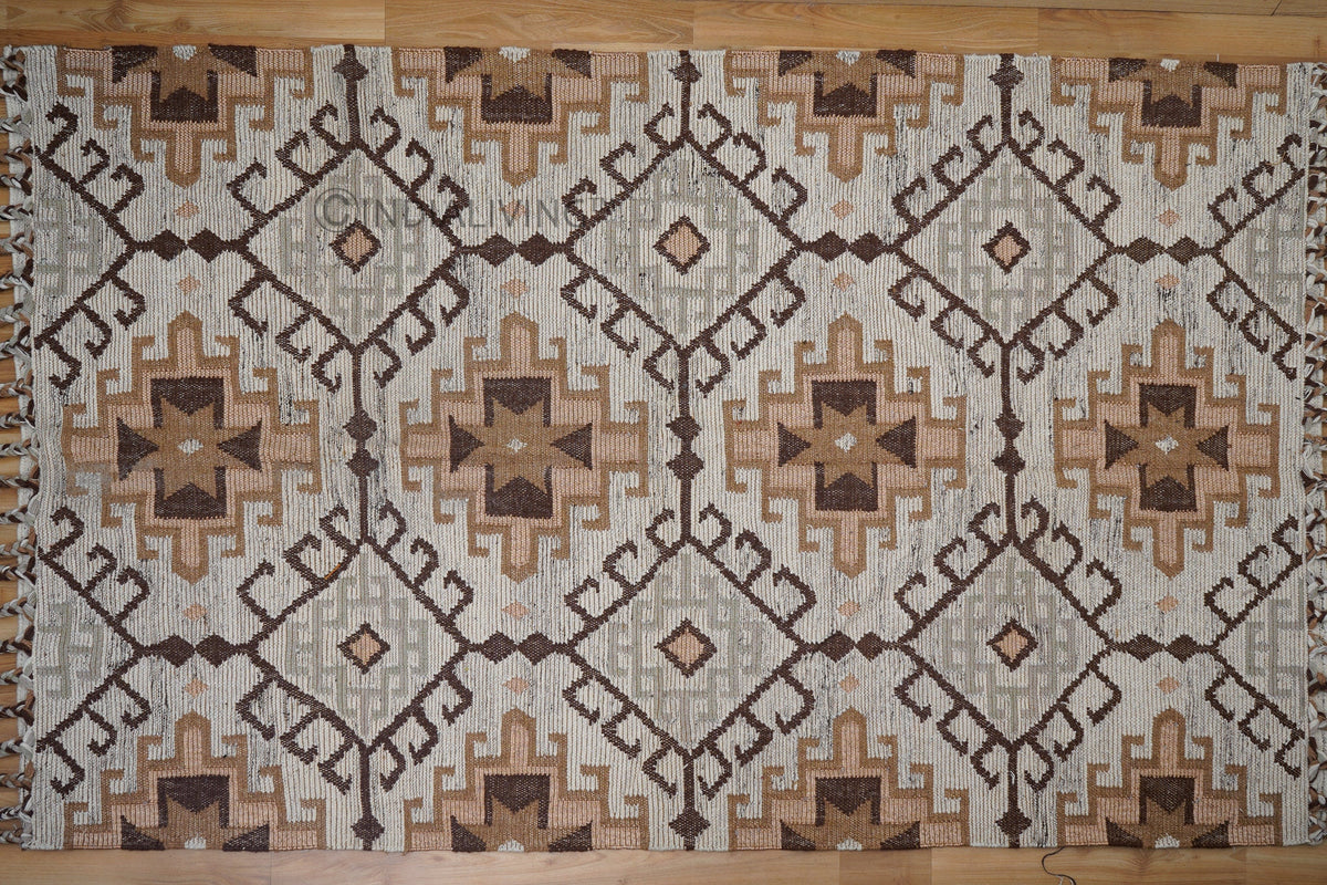 Brown beige kilim rug styled in a minimalist living room