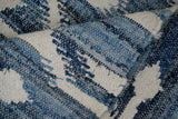 Close-up of denim blue weave and fringe detail