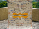 Beige rug corner detail with fringe edge