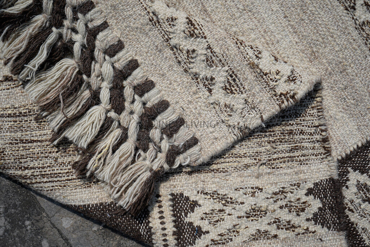 Close-up of handwoven texture on farmhouse rug