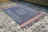 Blue kilim rug in a bedroom setting