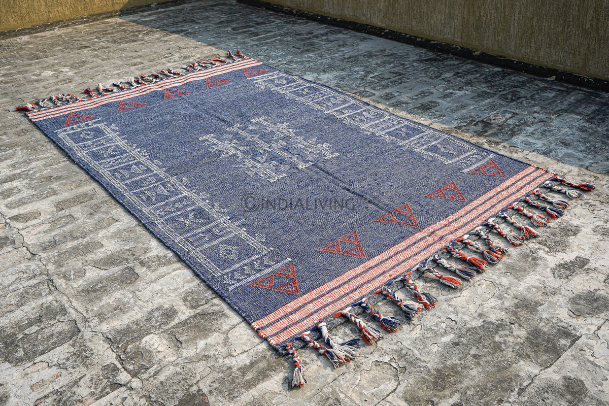 Blue kilim rug in a bedroom setting