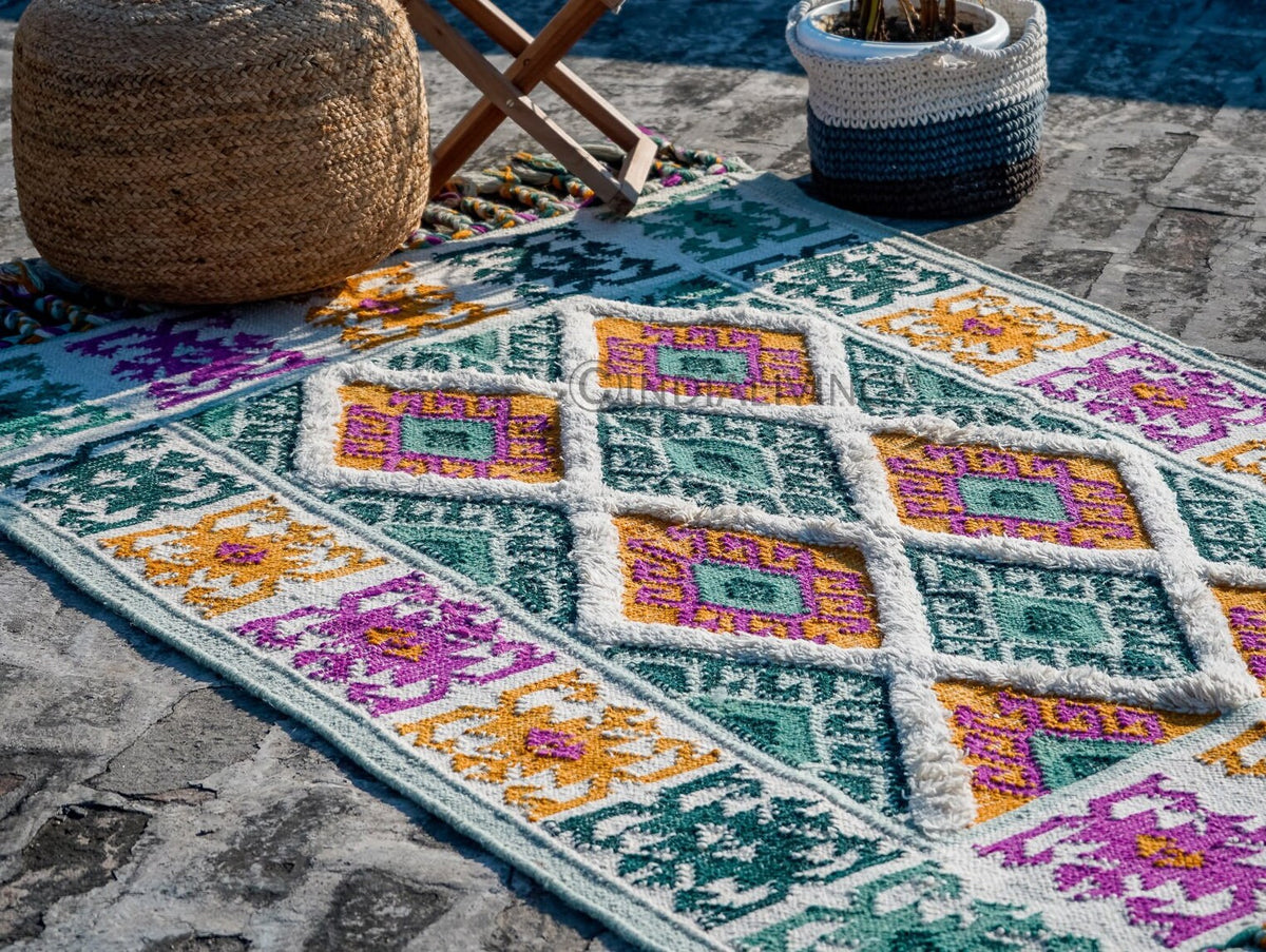Green rug corner detail with fringe edge