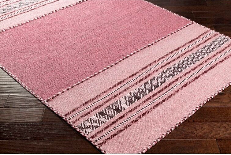 Pink kilim rug styled with boho decor