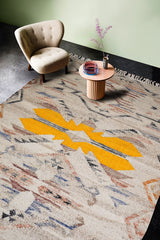 Beige abstract rug styled in a modern living room