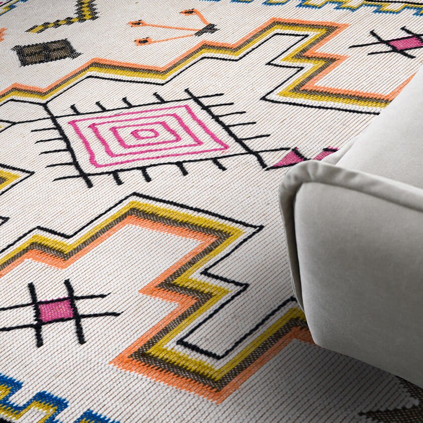 Ivory flatweave rug in an indoor outdoor setting