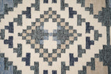 Full view of beige blue abstract kilim rug on floor