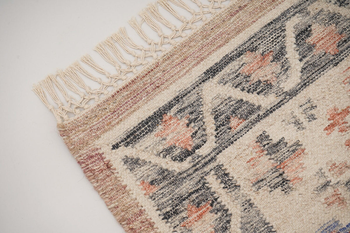 Corner detail of pink kilim rug edge