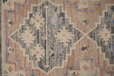 Pink vintage kilim rug styled with antique home decor