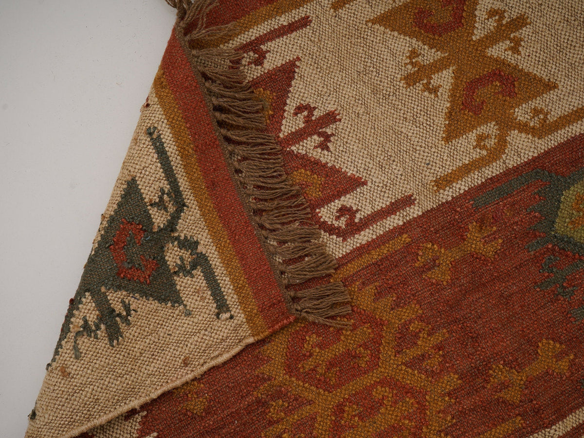 Red Navajo kilim runner texture close-up of wool-jute weave