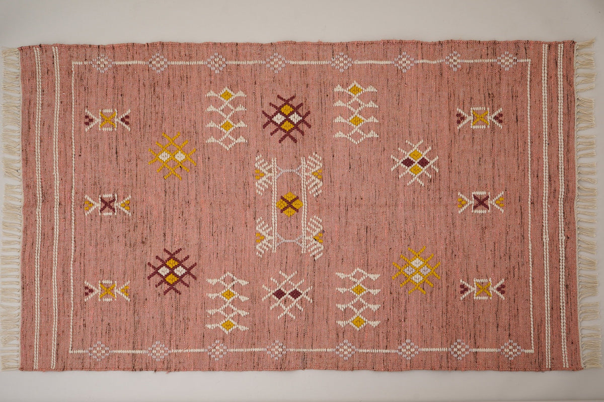 Close-up of pink kilim rug tribal pattern