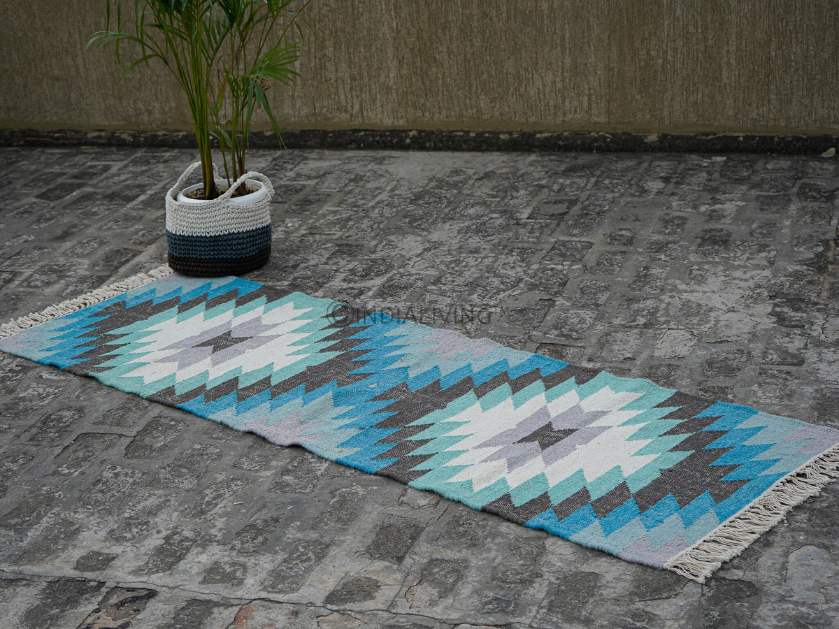 Blue kilim runner styled beside furniture