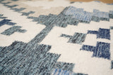 Beige blue kilim rug under a coffee table