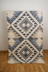 Beige blue rug corner detail with fringe edge
