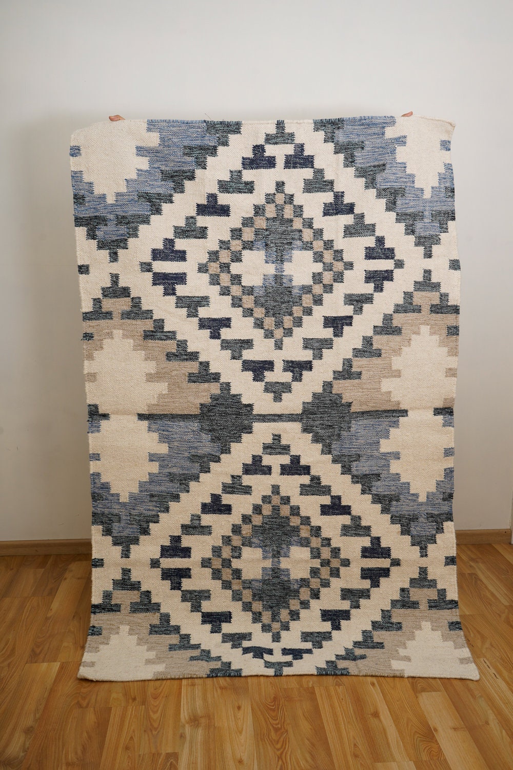 Beige blue rug corner detail with fringe edge