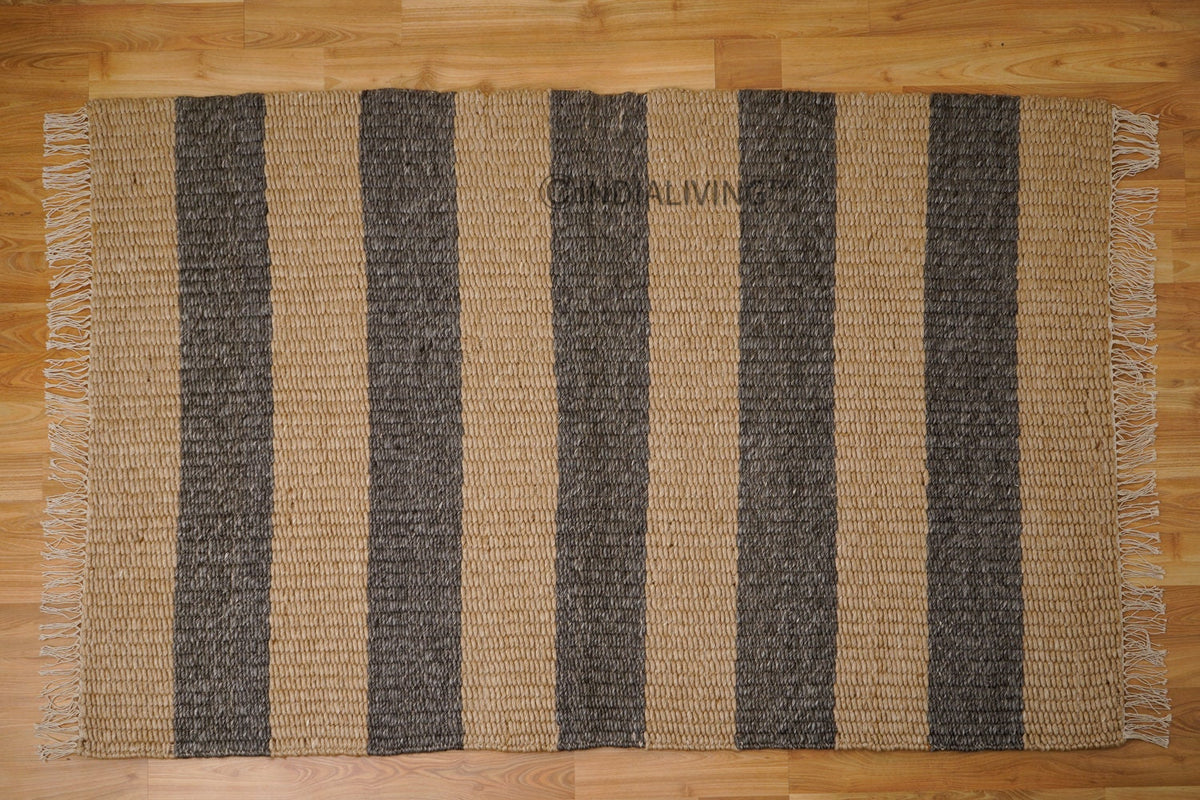Charcoal and beige striped chunky wool rug in bedroom setting