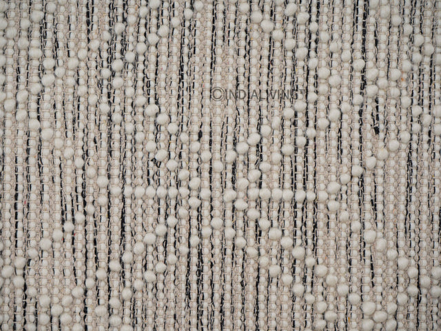 Beige wool rug styled in a living room