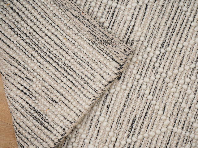 Beige textured chunky wool rug flat lay