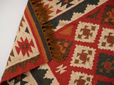 Overhead view of Aztec-inspired pattern on red rug