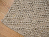 Beige chunky wool rug flat lay