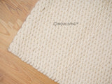 Ivory oversized wool rug styled in a living room