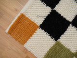 Checkered wool rug styled in a living room