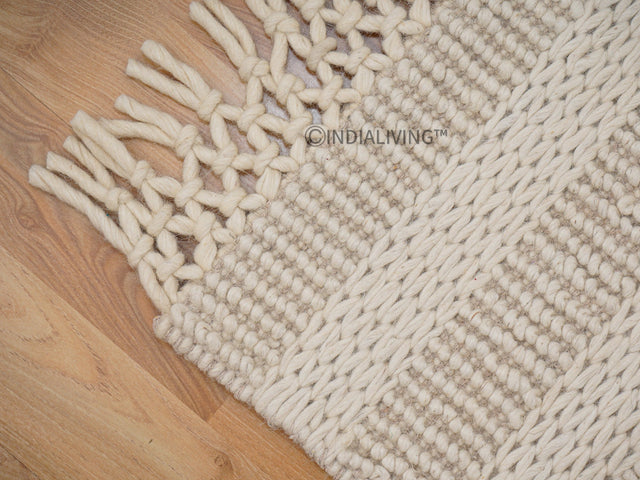 Ivory wool rug styled in a living room
