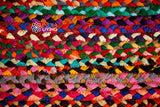 Rainbow rag rug styled in a bedroom