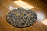 Round chindi rug shown in bedroom setting
