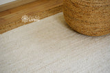 Off-white jute rug styled in a kitchen