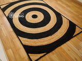 Black ring jute rug styled with furniture in room