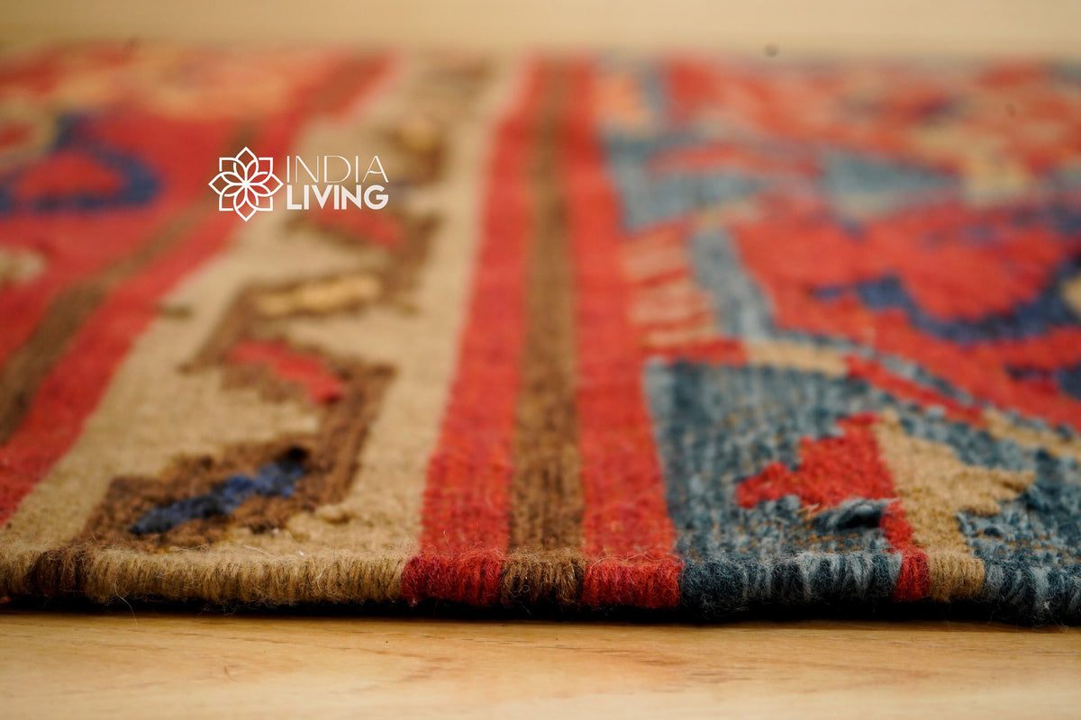 Red Afghan style kilim rug texture close-up