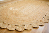 Jute oval rug styled in an entryway setting
