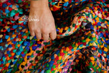 Rainbow rag rug styled in a living room