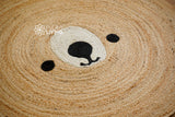 Bear face rug corner detail with orange border
