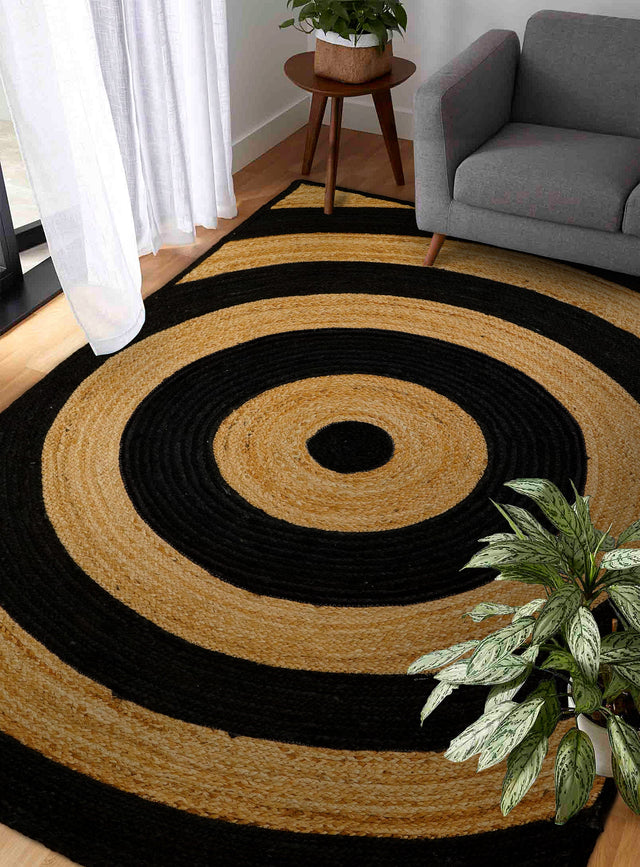 Black ring jute rug styled in a living room