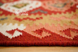Red traditional kilim rug texture close-up