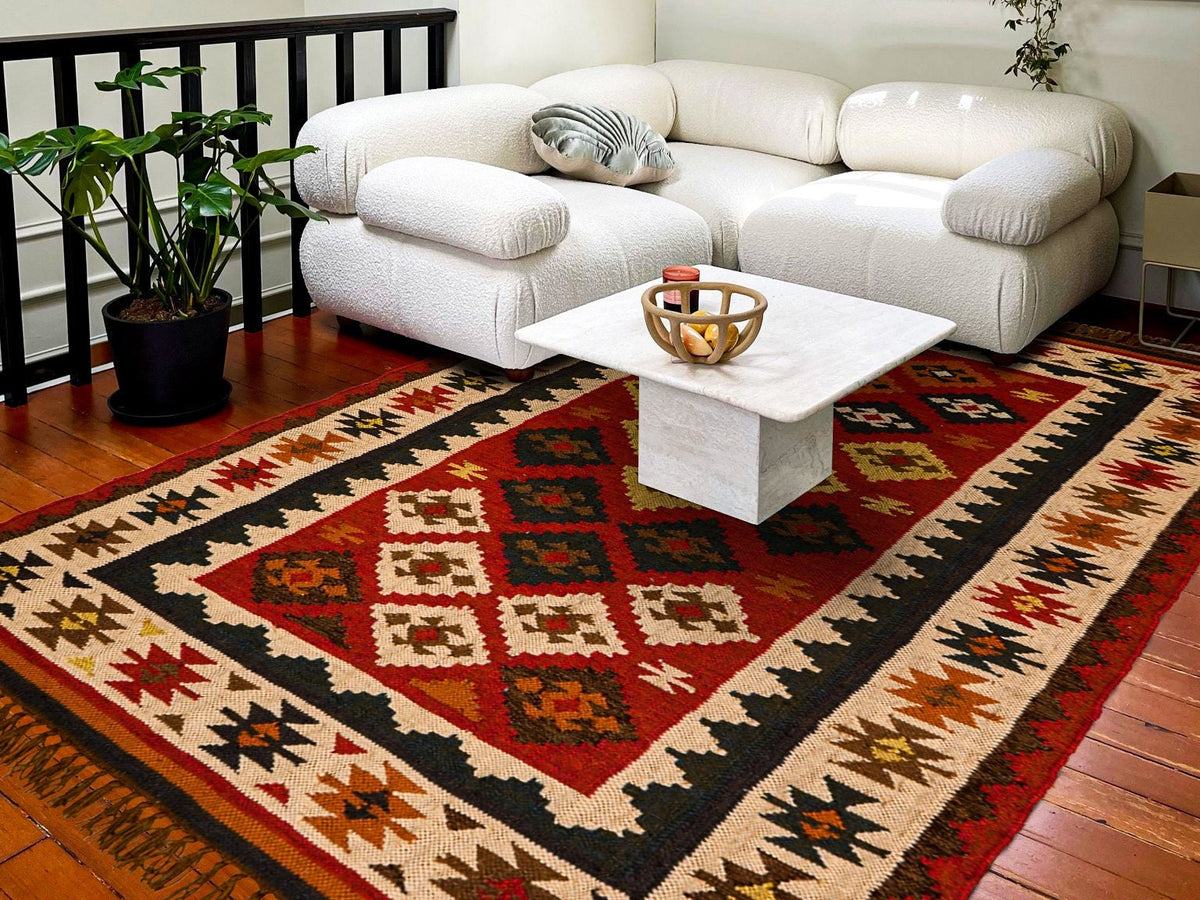 Corner detail of red kilim rug geometric edge