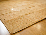 Handwoven jute area rug flat lay showing square pattern