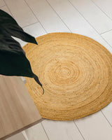 Round jute mat styled in an entryway