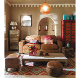 Rainbow diamond pattern rug styled near a sofa