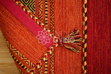 Close-up of cotton chenille weave texture on red kilim rug