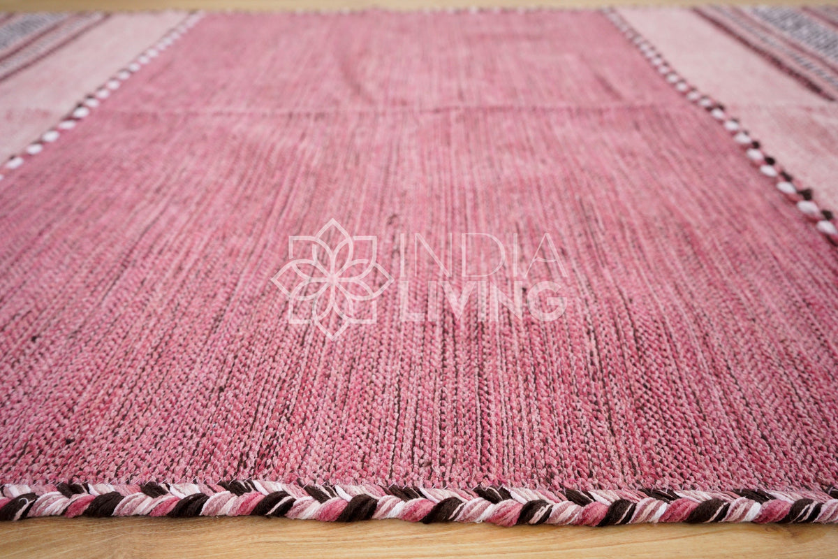 Overhead view of pink kilim rug