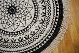 Full view of round bohemian mat on wood floor