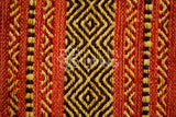 Red kilim rug under a dining table lifestyle shot