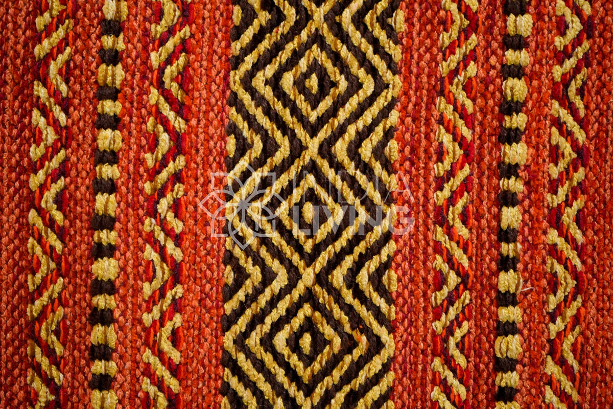 Red kilim rug under a dining table lifestyle shot